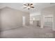 Spacious bonus room with plush carpet, ceiling fan, and convenient access to storage at 3060 Drummond Ave, Indian Land, SC 29707