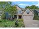Charming home featuring a landscaped front yard, a two-car garage and a welcoming porch at 3060 Drummond Ave, Indian Land, SC 29707