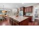 Gourmet kitchen boasts a large center island, stainless steel refrigerator, and custom cabinetry at 3060 Drummond Ave, Indian Land, SC 29707