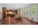Open kitchen and breakfast area featuring hardwood floors, an island, and lots of natural light at 3060 Drummond Ave, Indian Land, SC 29707