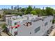 An aerial view of the modern townhome exteriors with a rooftop patio and the Charlotte skyline in the background at 310 Wesley Heights Way, Charlotte, NC 28208