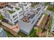 Aerial shot of modern townhome exteriors with rooftop patio and attached garages and lush landscaped yards at 310 Wesley Heights Way, Charlotte, NC 28208