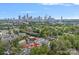 An aerial view of the home and property, near the city skyline, green trees and lush landscaping at 310 Wesley Heights Way, Charlotte, NC 28208