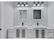 Bright bathroom featuring a double sink vanity, square mirrors, and modern black fixtures at 310 Wesley Heights Way, Charlotte, NC 28208