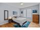 Well lit bedroom featuring a queen size bed, wood floors, and modern decor at 310 Wesley Heights Way, Charlotte, NC 28208