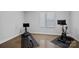 Home gym featuring modern exercise equipment and natural light at 310 Wesley Heights Way, Charlotte, NC 28208