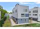 Modern townhome showcasing contemporary architecture, gray siding, and well-kept landscaping at 310 Wesley Heights Way, Charlotte, NC 28208