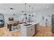 Modern kitchen open to living area featuring stainless appliances, island with sink, and hardwood floors at 310 Wesley Heights Way, Charlotte, NC 28208
