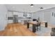 Bright, open kitchen featuring modern appliances, a large island, and a seamless flow into the dining area at 310 Wesley Heights Way, Charlotte, NC 28208