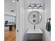 A stylish powder room featuring a sleek vanity, modern fixtures, and a well-lit mirror at 310 Wesley Heights Way, Charlotte, NC 28208