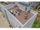 Aerial view of rooftop deck with seating, tables and brick pavers, ideal for entertaining at 310 Wesley Heights Way, Charlotte, NC 28208