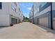 Modern townhouses line a street with driveways and garages in a well-maintained community setting at 310 Wesley Heights Way, Charlotte, NC 28208