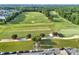 Aerial view of a lush golf course with a parking area and tree-lined paths, showcasing a serene recreational landscape at 374 Horton Grove Rd, Fort Mill, SC 29715