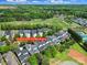 Aerial view showing the neighborhood and nearby golf course, tennis courts, mature landscaping and other community amenities at 374 Horton Grove Rd, Fort Mill, SC 29715