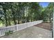 Backyard with white picket fence and trees providing shade on a brick patio, creating a private outdoor space at 374 Horton Grove Rd, Fort Mill, SC 29715