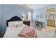 Cozy bedroom features blue walls, a comfortable bed, and a small workspace with natural light at 374 Horton Grove Rd, Fort Mill, SC 29715