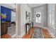 Entryway with hardwood floors, neutral walls, decorative table and rug leading to a brightly lit office space at 374 Horton Grove Rd, Fort Mill, SC 29715