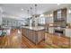 Open kitchen with hardwood floors, granite countertops, large island, stainless appliances and modern lighting at 374 Horton Grove Rd, Fort Mill, SC 29715