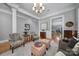 Bright living room with hardwood floors, neutral paint, decorative seating and doorway to kitchen in the background at 374 Horton Grove Rd, Fort Mill, SC 29715