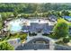 Stunning aerial view of a pool area with waterslides, umbrellas, and a beautiful clubhouse at 374 Horton Grove Rd, Fort Mill, SC 29715