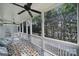 Outdoor porch features a ceiling fan, screened windows with backyard tree views, and space for seating at 374 Horton Grove Rd, Fort Mill, SC 29715
