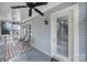 Charming outdoor porch with a ceiling fan, screened windows, and a cozy seating area at 374 Horton Grove Rd, Fort Mill, SC 29715