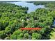 Stunning aerial view of wooded acreage, with lake views and the address clearly visible at 4 Hummingbird Ct, Clover, SC 29710