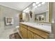 A large bathroom with double vanity with gold fixtures, marble tile floor, and neutral paint at 4 Hummingbird Ct, Clover, SC 29710