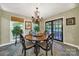 Cozy dining area with a round table, chandelier, and access to the outdoor deck through glass doors at 4 Hummingbird Ct, Clover, SC 29710