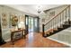Bright foyer with hardwood floors, staircase, chandelier, and an inviting front door with glass at 4 Hummingbird Ct, Clover, SC 29710