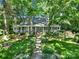 Charming home with a sprawling front porch and beautifully landscaped front yard with mature trees at 4 Hummingbird Ct, Clover, SC 29710