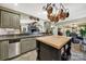 This open concept kitchen includes an island with wood top, stainless steel dishwasher, and a view to a living space at 4 Hummingbird Ct, Clover, SC 29710