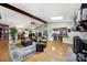 Open-concept living room with vaulted ceilings, a fireplace, wood floors, and abundant natural light from a skylight at 4 Hummingbird Ct, Clover, SC 29710