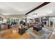 Expansive living room with a fireplace, vaulted ceiling, wood floors, and an open floor plan to other living spaces at 4 Hummingbird Ct, Clover, SC 29710