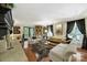 Bright living room boasts hardwood floors, a decorative fireplace, and comfortable seating areas at 4 Hummingbird Ct, Clover, SC 29710