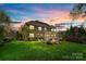 Exterior image of a two story house with a beautiful backyard and covered patio area at 405 Five Leaf Ln, Waxhaw, NC 28173