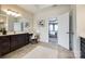 Bathroom showcasing a vanity with a seated makeup area and a connecting door to the bedroom at 405 Five Leaf Ln, Waxhaw, NC 28173