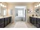 Bathroom with separate vanities, a soaking tub and a walk-in shower offers plenty of space at 405 Five Leaf Ln, Waxhaw, NC 28173