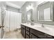 Bathroom featuring double sinks, decorative mirrors, and shower with tub at 405 Five Leaf Ln, Waxhaw, NC 28173