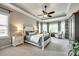 Spacious bedroom with trey ceiling, large windows, sitting area, and soft carpeting, creating a relaxing retreat at 405 Five Leaf Ln, Waxhaw, NC 28173