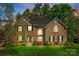 Beautiful two-story brick home with a well-manicured lawn and colorful landscaping at 405 Five Leaf Ln, Waxhaw, NC 28173