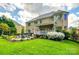 Large brick home with covered patio and landscaped backyard at 405 Five Leaf Ln, Waxhaw, NC 28173
