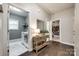 Bright hallway featuring hardwood floors and views of the laundry room and a bedroom with built-in bookcases at 405 Five Leaf Ln, Waxhaw, NC 28173