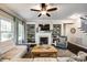 Inviting living room features a fireplace, built-in shelving, ceiling fan and a comfortable seating area at 405 Five Leaf Ln, Waxhaw, NC 28173