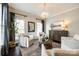 Relaxing living room with hardwood floors, an area rug, and a decorative chandelier at 405 Five Leaf Ln, Waxhaw, NC 28173