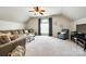 Spacious living room features vaulted ceilings, a ceiling fan, and a large window for ample light at 405 Five Leaf Ln, Waxhaw, NC 28173