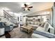 Open-concept living room with hardwood floors, a comfortable sofa, and a view of the kitchen at 405 Five Leaf Ln, Waxhaw, NC 28173