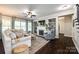 Inviting living room with a fireplace, built-in bookshelves, and a comfortable seating area at 405 Five Leaf Ln, Waxhaw, NC 28173