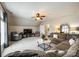 Bright living room features vaulted ceilings, a ceiling fan, and a large sectional sofa at 405 Five Leaf Ln, Waxhaw, NC 28173