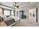 Spacious primary bedroom features a tray ceiling, ceiling fan, sitting area, and ensuite bath at 405 Five Leaf Ln, Waxhaw, NC 28173